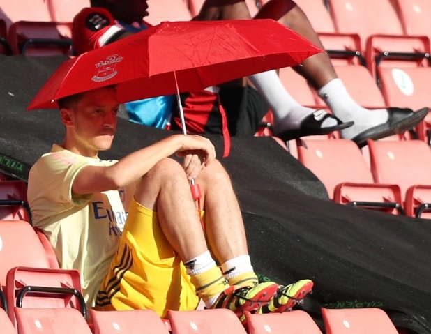 Mesut Ozil with umbrella